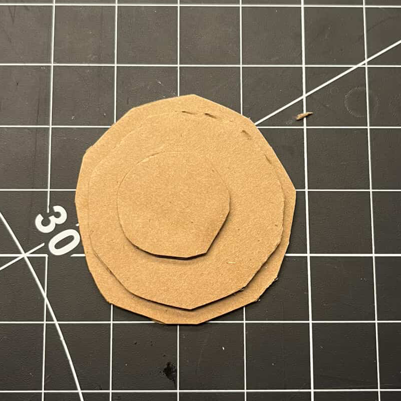 Cutting out the basic shapes of different-sized circles.